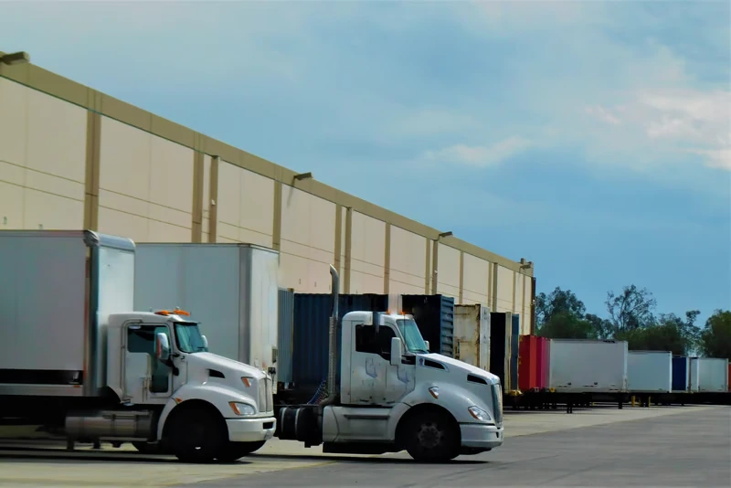 Cross Docking Toronto warehouse with trucks loading freight at distribution facility